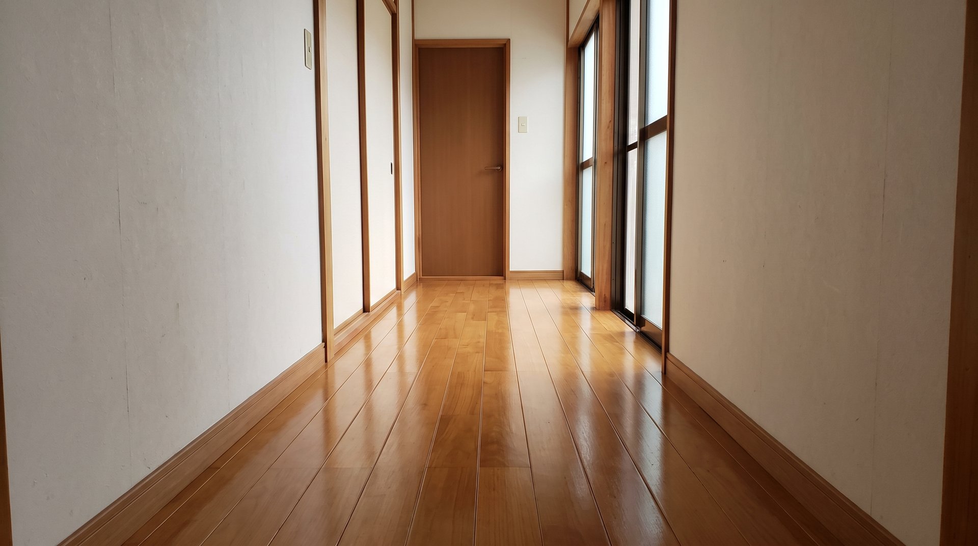 塗装でつやが戻ったフローリングと室内の木のドア(イメージ)